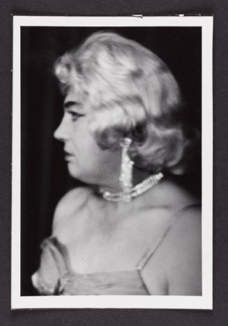 [Blonde wearing diamanté jewelry, location unknown]
