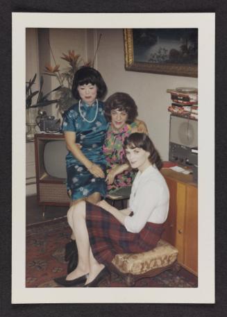 [Lili, Susanna and friend sitting in a living room, location unknown]
