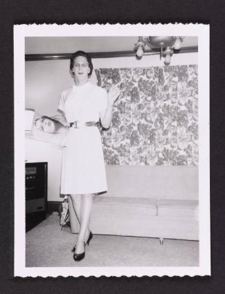 [Beverly holding a copy of Vogue, location unknown]
