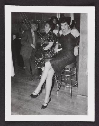 [Carlene sitting on a barstool in a black dress, Chevalier d'Eon, Hunter, NY]
