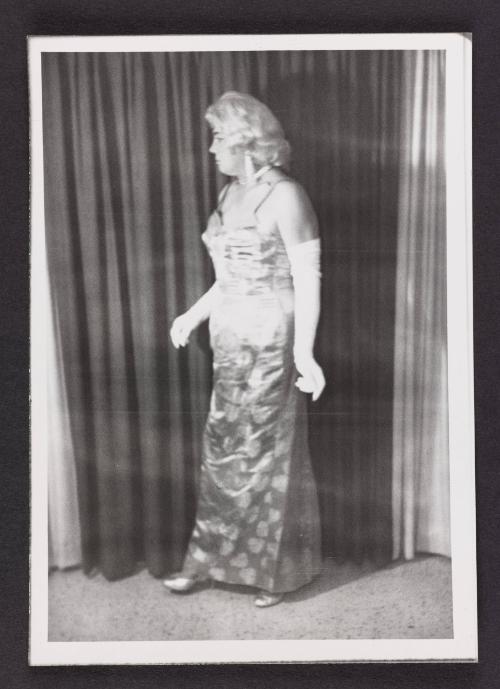 [Blonde in brocade dress, location unknown]
