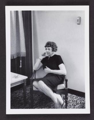 [Anita holding a cigarette, location unknown]
