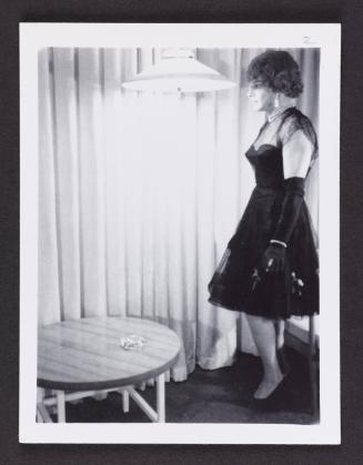 [Anita in a black dress, location unknown]
