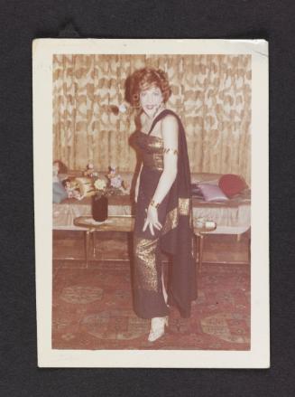 [Susanna with a rose in her teeth in her New York City apartment]
