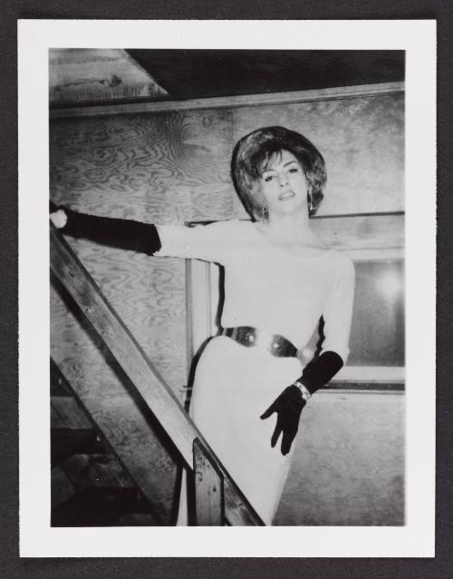 [White dress and black gloves, posing on the stairs, location unknown]
