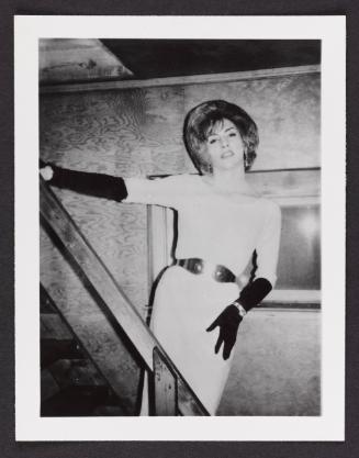 [White dress and black gloves, posing on the stairs, location unknown]
