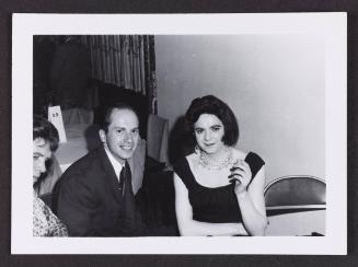 [Karen sitting with a man in a suit, location unknown]
