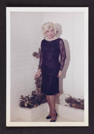[Gloria in a black lace dress, location unknown]
