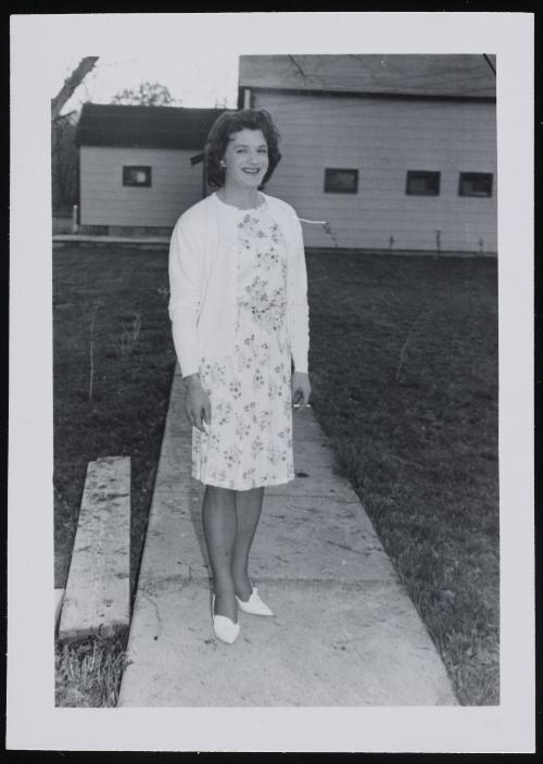 [Brunette holding a cigarette, standing on a walkway, Chevalier d’Éon, Hunter, NY]
