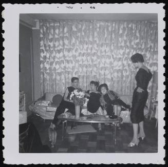 [Marie and three friends in the New York City apartment]
