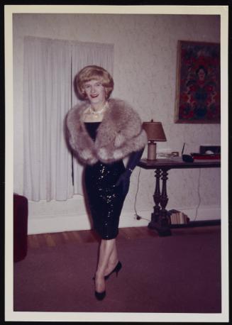 [Jody in a sequin dress and fur stole, location unknown]
