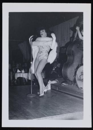 [Performing on stage in a sequin outfit and boa, location unknown]
