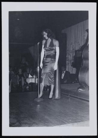 [Performing in a satin dress and long white gloves, location unknown]
