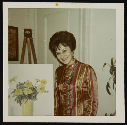 [Beside a painting of flowers, location unknown]
