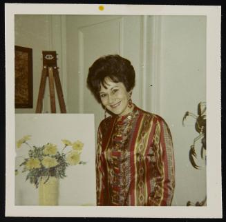 [Beside a painting of flowers, location unknown]
